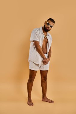 A bearded man with a white shirt and shorts walks confidently, exuding a sense of casual elegance and free-spirited charm. clipart