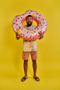 A man with a giant donut in one hand and a glass of beer in the other, enjoying the indulgent combination of sweet and savory flavors. clipart