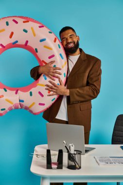 A man is holding a massive donut in front of a laptop, seemingly interacting with the screen. The juxtaposition of the sweet treat and technology creates a whimsical and surreal scene. clipart