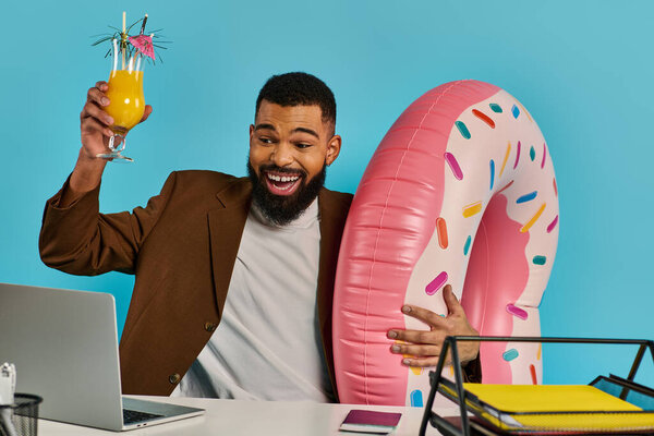 A man with a thoughtful expression sits at a desk, holding a glass of refreshing orange juice.