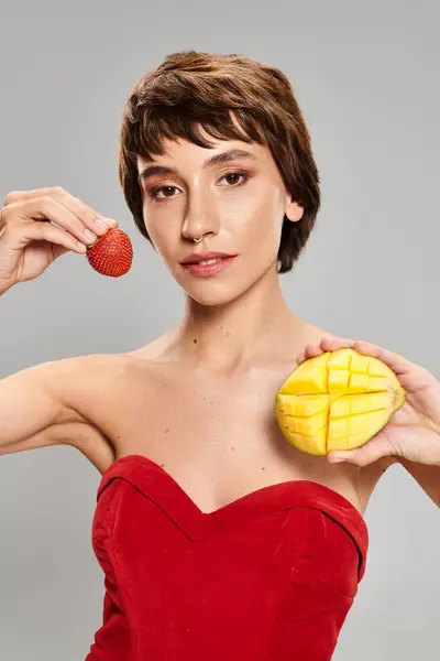 Young Woman Red Dress Holding Piece Fruit — Φωτογραφία Αρχείου