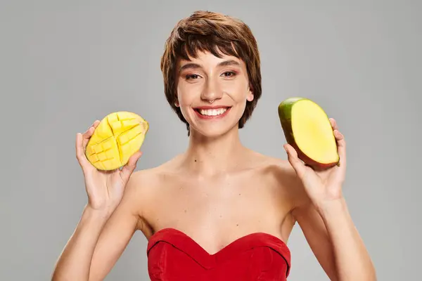 Young Woman Red Dress Holding Two Fruit Pieces — Stockfoto