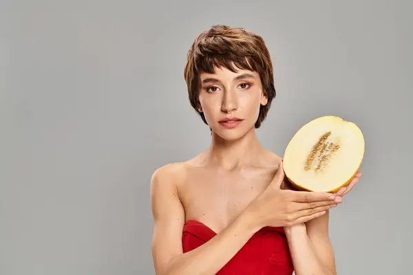 Woman Red Dress Seductively Holds Apple — Stock Photo, Image