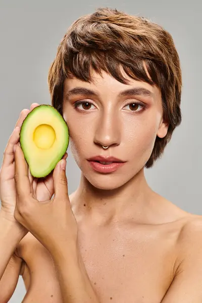Woman Playfully Holds Avocado Front Her Face — Stock Photo, Image