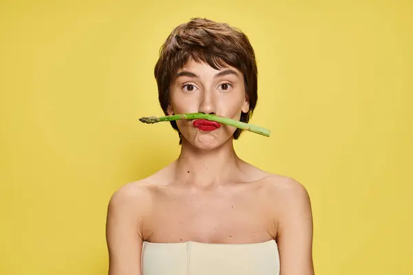 Elegant Woman Holds Asparagus Mouth Vibrant Backdrop —  Fotos de Stock