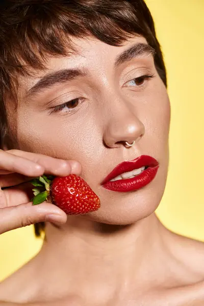 Young Woman Embraces Luscious Strawberry Her Cheek Radiating Bliss — Φωτογραφία Αρχείου