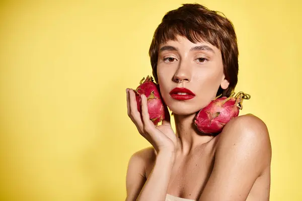 Young Woman Playfully Holding Fruit Front Her Face Vibrant Backdrop — Stock Photo, Image
