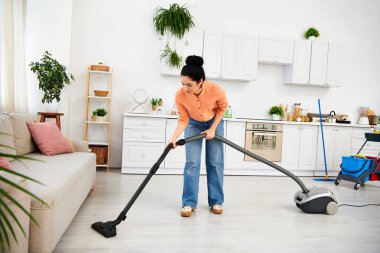 A stylish woman in casual attire efficiently vacuums her living room, bringing order and cleanliness to the space. clipart