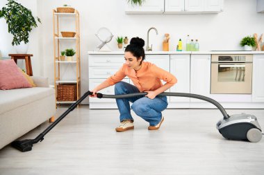 A stylish woman in casual attire gracefully vacuums the floor with her sleek vacuum cleaner, bringing cleanliness to her home. clipart