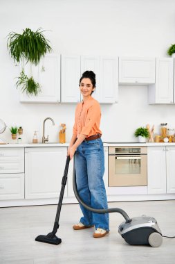 A stylish woman in casual attire gracefully vacuums the floor of her home. clipart