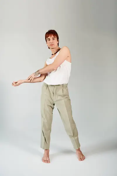 Stylish Young Man Strikes Pose Studio Setting Wearing White Tank — Stock Photo, Image