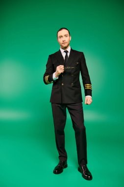 A handsome male pilot in a black uniform strikes a pose against a vibrant green backdrop. clipart