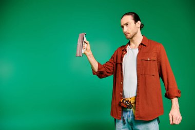 Male craftsman in a red shirt showcasing his work with polisher. clipart