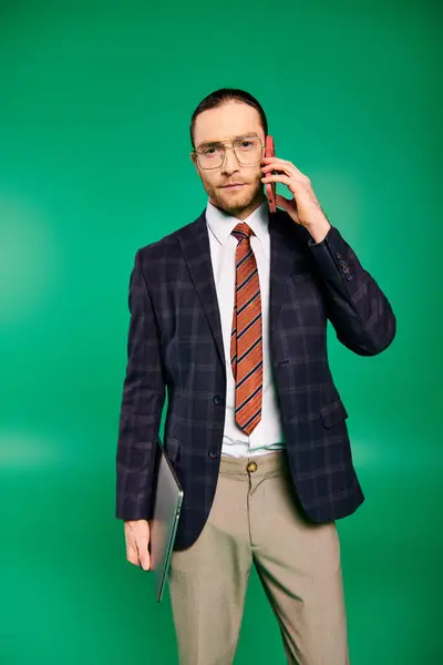 stock image A handsome businessman in a chic suit talking on a cell phone.