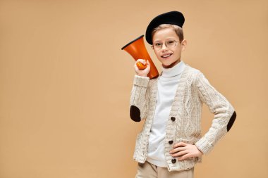 Young boy in film director costume, holding a megaphone. clipart