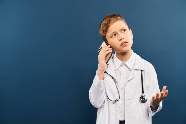 A preadolescent boy in a white coat, holding a stethoscope, looking ready to help. clipart