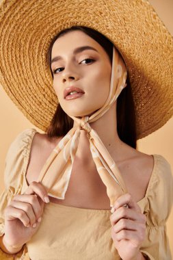 A young woman with long brunette hair poses in a summer outfit, wearing a straw hat and scarf, exuding a serene and sun-kissed vibe. clipart