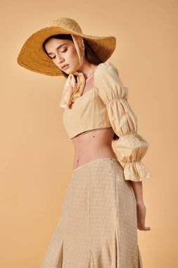 A fashionable young woman with long brunette hair striking a pose in a stylish hat and skirt, exuding a summery vibe in a studio setting. clipart