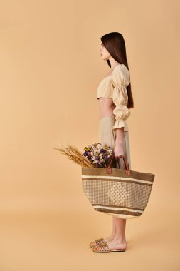 A young woman with long brunette hair elegantly holds a basket filled with colorful flowers, exuding a vibrant summer mood. clipart