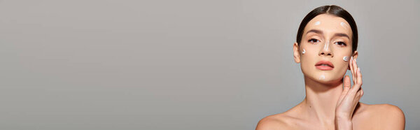 Молодая женщина с брюнетками, руки на лице, изображающая эмоции печали или созерцания.