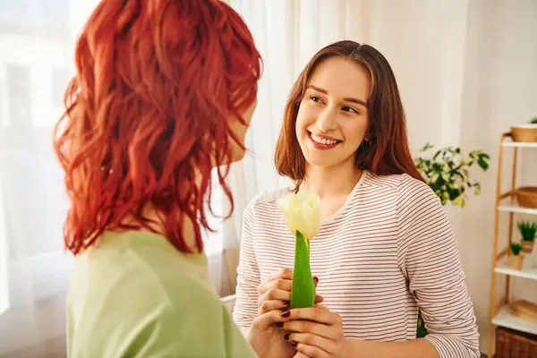 Tender Moment Lesbian Couple Woman Gifting Tulip Her Happy Girlfriend — стоковое фото