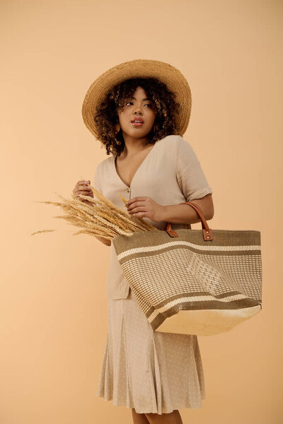 A young African American woman with curly hair and a summer dress, holding a bag and wearing a straw hat.