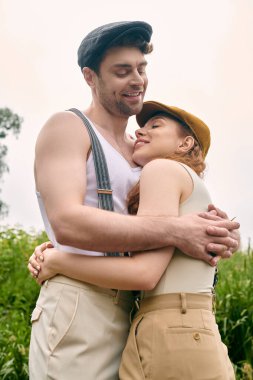 A man and woman lovingly embrace in a lush green field, surrounded by the beauty of nature. clipart