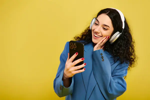 Young Brunette Woman Curly Hair Wearing Headphones Holding Cell Phone — Stok fotoğraf