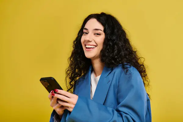 Young Brunette Woman Curly Hair Blue Robe Confidently Holding Cell Stockfoto