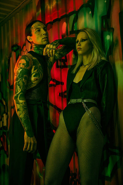 A couple standing side by side at a rave party or nightclub