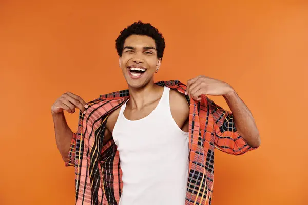 Joyful African American Man Vibrant Clothing Posing Orange Backdrop Looking — Stock Photo, Image