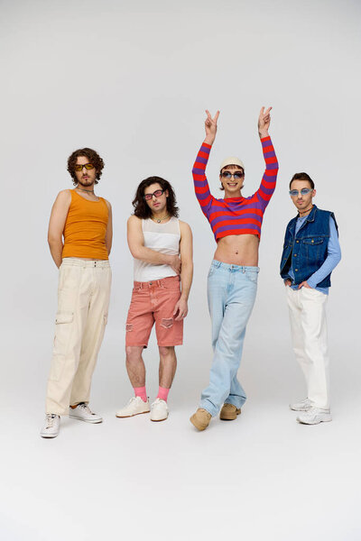 four elegant cheerful gay friends with stylish sunglasses posing actively together, pride month