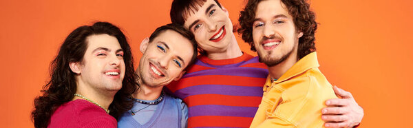 four attractive cheerful gay men in vibrant clothes posing together actively, pride month, banner