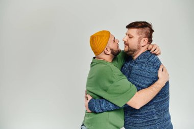 A close-up moment of two men tenderly embracing each other, showcasing love and connection. clipart