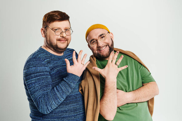 Two men stand facing each other, posing for a picture.