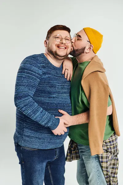 stock image A loving gay couple stands together.