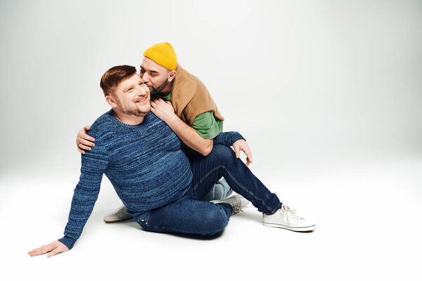 Two men peacefully sitting one on top of the other.