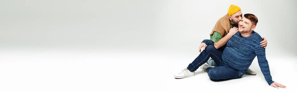 A couple sitting peacefully on the ground.