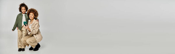 Two children, exuding innocence and joy, strike a pose in front of a plain white background.