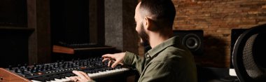 A talented man delves into his electronic keyboard, crafting harmonious melodies in a dynamic recording studio setting. clipart