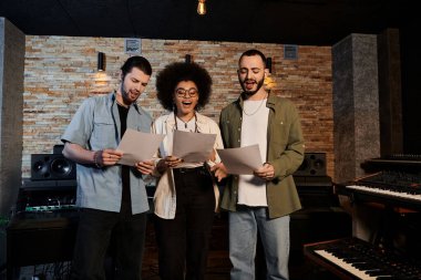 A diverse group of people, members of a music band, stand in a recording studio, preparing for a rehearsal session. clipart