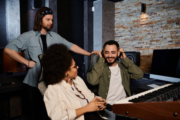 A music band is rehearsing in a recording studio, surrounded by microphones, instruments, and sound equipment.