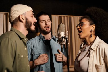 Three individuals passionately singing into a microphone while rehearsing in a recording studio. clipart