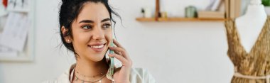 A young woman in casual attire converses on a cell phone in a room. clipart