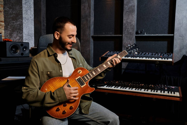 A skilled man passionately plays an electric guitar in a recording studio during a music band rehearsal.