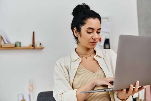 Young woman upcycles clothes on laptop for sustainable fashion.