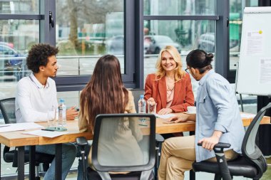 Group of professionals discussing in a conference room at the office. clipart