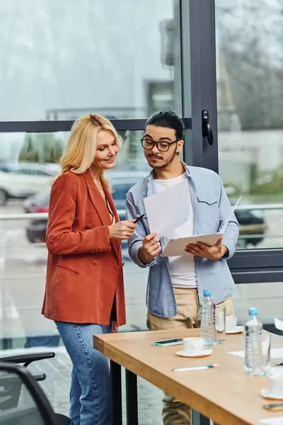 stock image Two professionals engrossed in a meeting in a modern conference room.