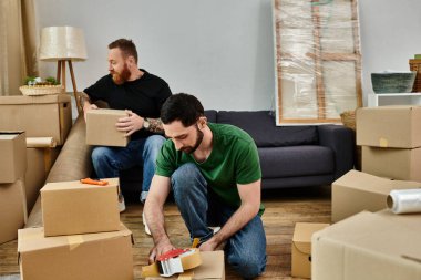 Two men, a loving gay couple, arranging boxes in a cozy living room while embarking on a new chapter in their life journey. clipart