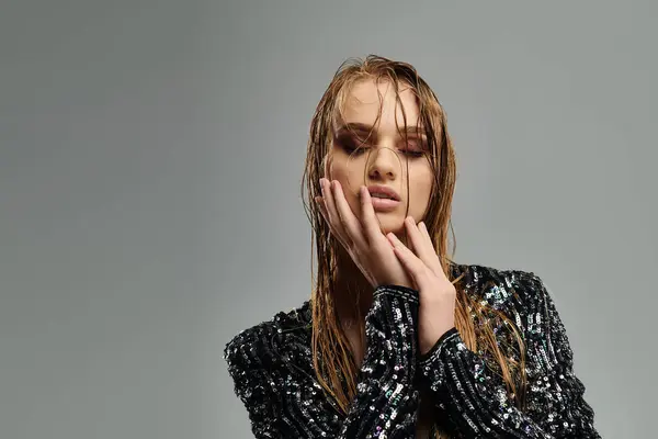 stock image A woman with long hair wears a shimmering sequin top.